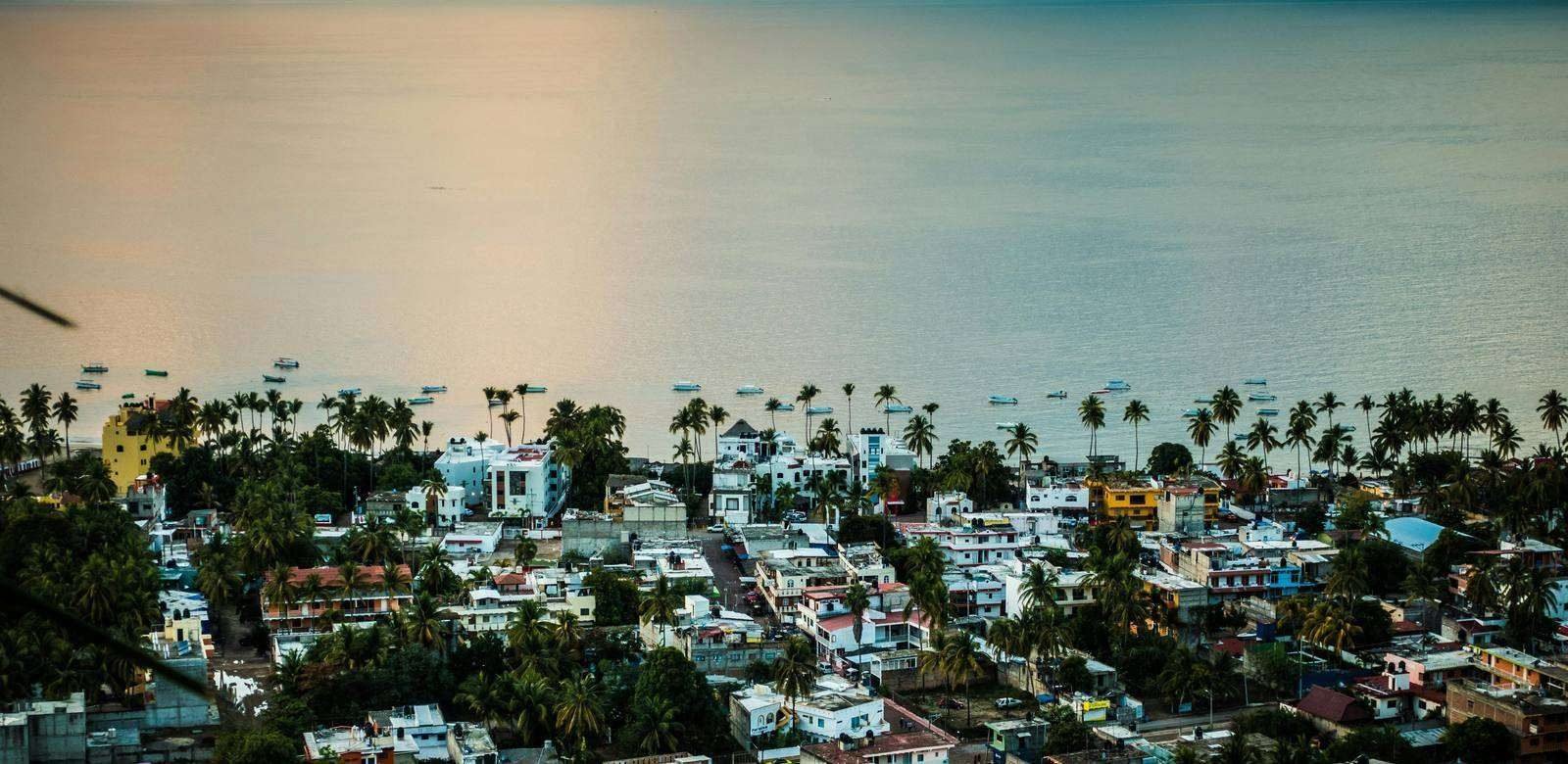 A coastal town at dusk, looking out toward open water